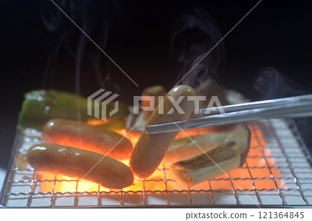 Smoke rising from a charcoal grill as a barbecue 121364845