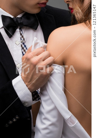 Sexy smart couple embracing shot in dark 121365147