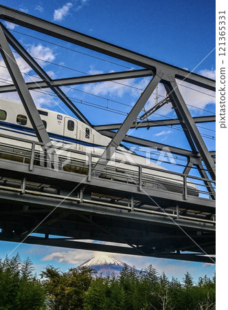 A Shinkansen train crossing the Fuji River Bridge with Mount Fuji in the distance A Shinkansen train crossing the Fuji River Bridge with Mount Fuji in the distance 121365331