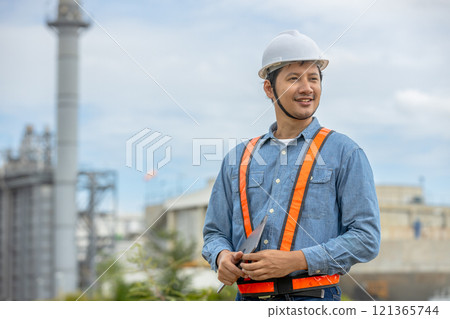 Engineer with tablet working factory producing electricity oil energy. Construction manager oil refinery in petrochemical. improvement inspector Industrial worker working power plant 121365744