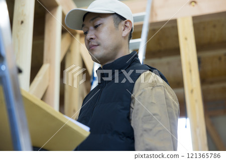 man working at construction site 121365786