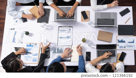Analyst team utilizing BI Fintech to analyze financial data at table. Prudent Analyst team utilizing BI Fintech to analyze financial data at table. Prudent 121366192