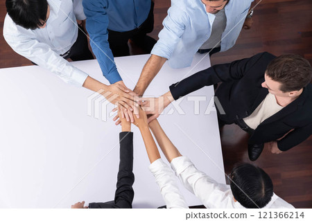 Group of diverse office worker join hand together in office. Prudent 121366214