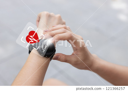 Close up person Point to smartwatch displaying heart rate application. Monitoring virtual display measure heart rate before after physical exercise. wristwatch checking heart beats and pulse. 121366257