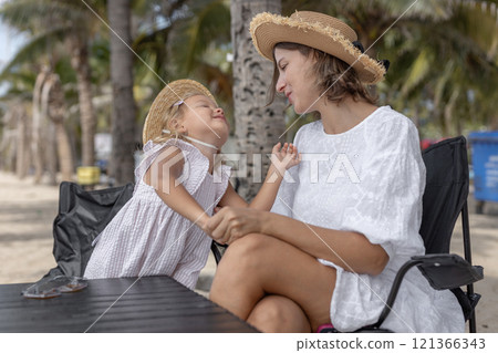 Happy mother hugging and baby daughter family vacation summer. Mother love for her child is bond moment of happy. Happy mother hugging and baby daughter family vacation summer. Mother love for her child is bond moment of happy. 121366343