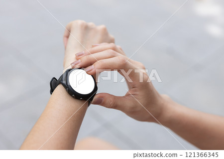 Person pointing touching at smart watch white screen display. White space of smart wristwatch use for text electronice, Message notifications, heart rate measurement during exercise. Clipping Path. Person pointing touching at smart watch white screen display. White space of smart wristwatch use for text electronice, Message notifications, heart rate measurement during exercise. Clipping Path. 121366345