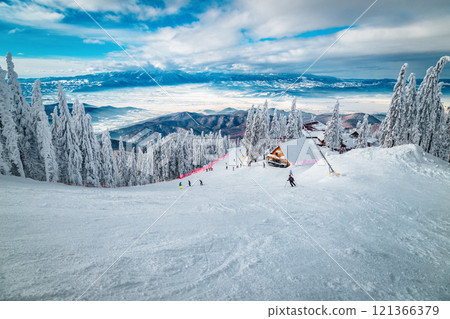 Skiers on the wide ski slope, Carpathians, Romania 121366379