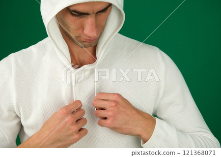 Portrait of funny Japanese man with dark hair winks eye smiles toothily dressed in casual sweatshirt feels joyful isolated over white background tries to make you laugh. People and emotions concept Portrait of funny Japanese man with dark hair winks eye smiles toothily dressed in casual sweatshirt feels joyful isolated over white background tries to make you laugh. People and emotions concept 121368071