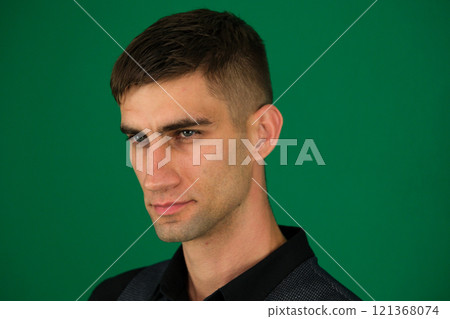 emotions of a handsome man guy on a green background chromakey close-up dark hair young man emotions of a handsome man guy on a green background chromakey close-up dark hair young man 121368074