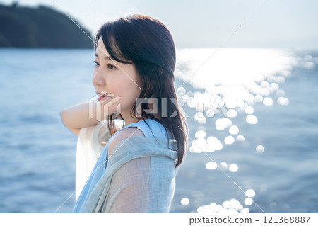 A woman refreshing in the sea 121368887