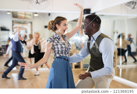 Pair dancing lindy hop during rehearsal 121369195