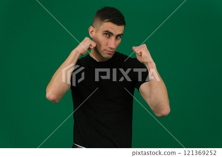 Young blond man wearing casual sweater Ready to fight with fist defense gesture, angry and upset face, afraid of problem 121369252