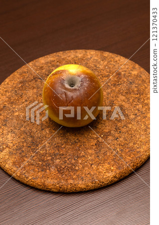 side view rotten apple on a white background. side view rotten apple on a white background. 121370433
