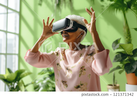 Digital World: An elderly black african woman explores the bliss of virtual reality in an apartment with lots of plants, escapism 121371342
