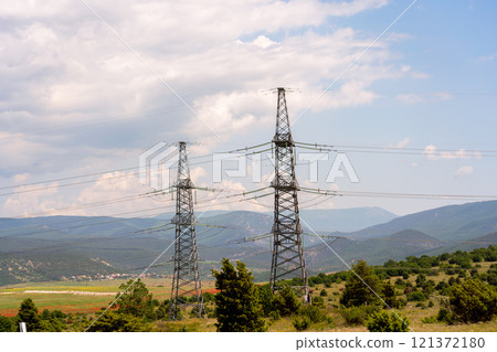 High voltage towers Electric pole. Power line support with wires for electricity transmission. High voltage grid tower with wire cable at distribution station. Energy industry, energy saving 121372180