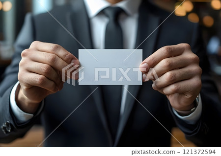 businessman holding visit card on hands, close, office background, ultrarealistic 121372594