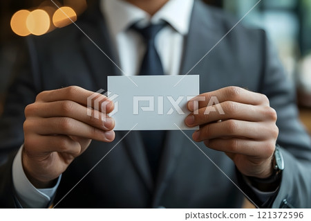 businessman holding visit card on hands, close, office background, ultrarealistic businessman holding visit card on hands, close, office background, ultrarealistic 121372596
