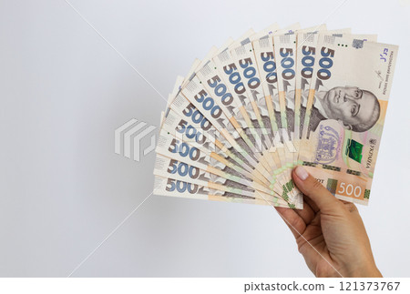 Ukrainian money. Ukrainian 500 banknotes in a female hand. 121373767