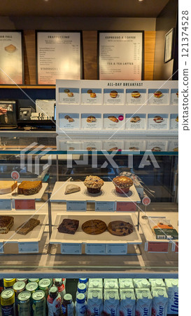 Starbucks Interior: Displayed Pastries and Menu Board 121374528