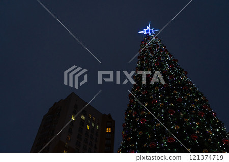 New Year's tree on the background of a multi-storey building 121374719