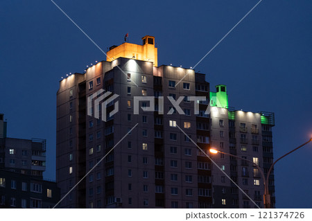 Illuminated panel, multi-storey buildings in the distance. An evening in Minsk 121374726