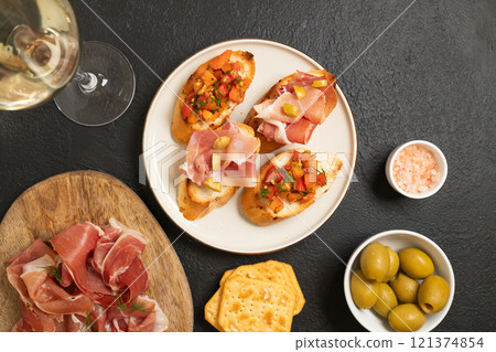 Tasty bruschetta served with wine on gray background Tasty bruschetta served with wine on gray background 121374854