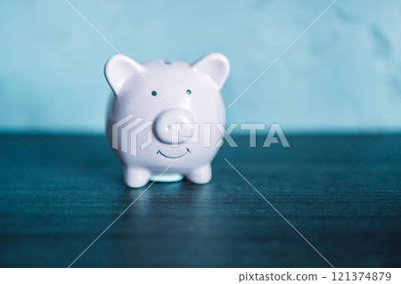 piggy bank with coin on old wooden table piggy bank with coin on old wooden table 121374879