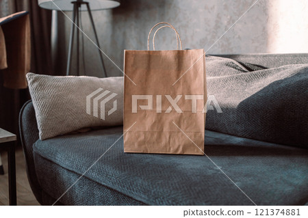 Shopping bag with boxes and shoes on sofa in room. Online business shopping concept. Shopping bag with boxes and shoes on sofa in room. Online business shopping concept. 121374881