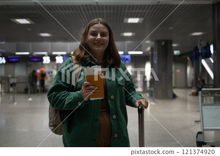Happy attractive Caucasian 30s woman traveler with backpack at the modern airport terminal. Tourist journey trip concept Happy attractive Caucasian 30s woman traveler with backpack at the modern airport terminal. Tourist journey trip concept 121374920