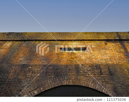Brick wall at the tunnel entrance 121375036
