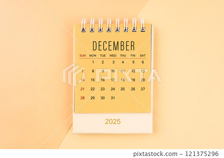 December 2025 mini desk calendar on the yellow, planning for business meeting. December 2025 mini desk calendar on the yellow, planning for business meeting. 121375296