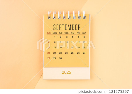 September 2025 mini desk calendar on the yellow, planning for business meeting. September 2025 mini desk calendar on the yellow, planning for business meeting. 121375297