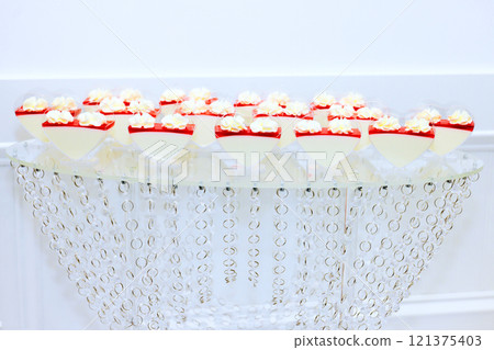 Beautifully arranged table showcases heart shaped desserts topped with cream elegant setting creates festive atmosphere for occasion. 121375403