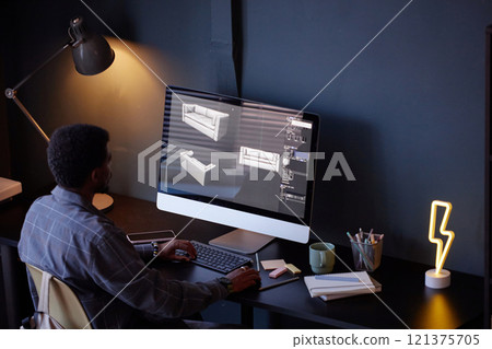 Man using computer software for designing furniture models while sitting at desk in modern office setting with comfortable atmosphere 121375705