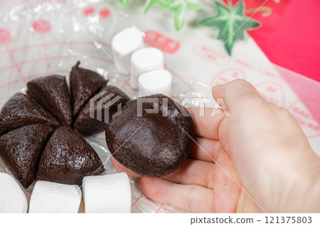 Wrapping marshmallows in cookie dough Wrapping marshmallows in cookie dough 121375803