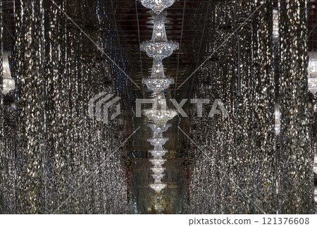 Interior decoration view of The sung crystal temple with complex featuring an adorned with shiny, mirrored tiles & columns and Glittering ceiling lights. 121376608