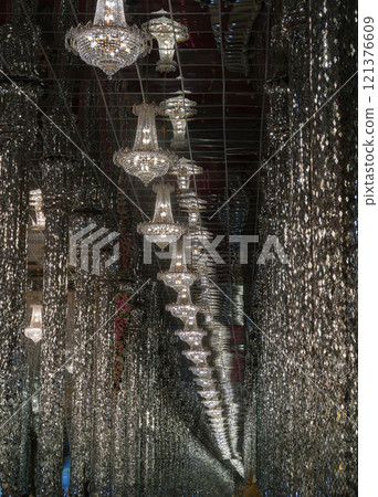 Perspective of Chandeliers ceiling and Glittering lights decoration inside of Chantaram temple. 121376609
