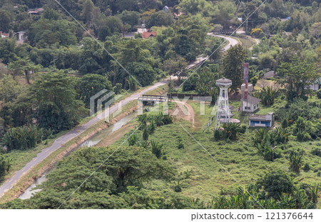 Canal and drainage system from Drainage Khun Dan Prakan Chon Dam with scenery cuts through lush green hills amidst landscape nature. Canal and drainage system from Drainage Khun Dan Prakan Chon Dam with scenery cuts through lush green hills amidst landscape nature. 121376644