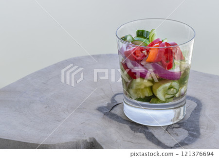 Homemade thai cucumber slices, chili slices and shallots relish slices and vinegar in a glass cup. Homemade thai cucumber slices, chili slices and shallots relish slices and vinegar in a glass cup. 121376694