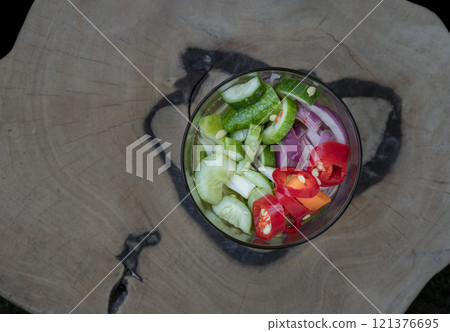 Top view of Homemade thai cucumber slices, chili slices and shallots relish slices and vinegar in a glass cup. Top view of Homemade thai cucumber slices, chili slices and shallots relish slices and vinegar in a glass cup. 121376695