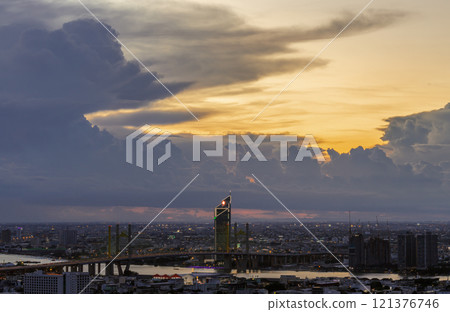Beautiful skyscrapers view and the Bridge crosses the Chao Phraya river of Bangkok city with Dramatic sky background at before sunset. Beautiful skyscrapers view and the Bridge crosses the Chao Phraya river of Bangkok city with Dramatic sky background at before sunset. 121376746
