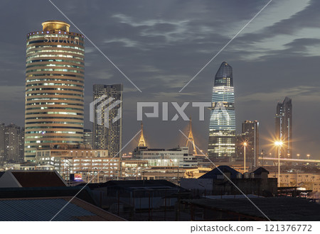 Stunning view of Skyscrapers in the business district with bright glowing lights in the night. 121376772