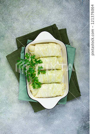 raw cabbage rolls, not cooked, with minced meat, top view, without people, in the spotlight. raw cabbage rolls, not cooked, with minced meat, top view, without people, in the spotlight. 121376864