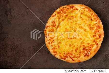 khachapuri in Megrelian, a traditional Georgian dish, flatbread with cheese, top view, no people, 121376866