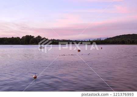 Pier at Sunset with Sailboats, Serene Lake Scene, Orange and Pink Sky, Calm Water, Silhouettes of Boats, Tranquil Evening, Reflections on Water, Peaceful Marina, Dusk Landscape, Nautical Atmosphere 121376993