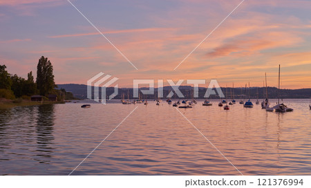 Sunset Overlooking Lake Bodensee in Germany. Bodensee Lake Sunset Panorama. Evening Sunlight Over Tranquil Waters. Sunset Vista at Lake Bodensee in Germany. 121376994
