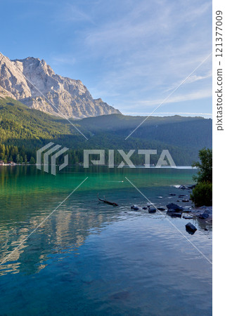 Scenic View of Eibsee Lake with Zugspitze Mountain at Sunset in Bavaria, Germany. Stunning Eibsee Lake with Zugspitze Reflection at Sunset in Bavaria, Germany. Tranquil Alpine Scene Captures the Scenic View of Eibsee Lake with Zugspitze Mountain at Sunset in Bavaria, Germany. Stunning Eibsee Lake with Zugspitze Reflection at Sunset in Bavaria, Germany. Tranquil Alpine Scene Captures the 121377009
