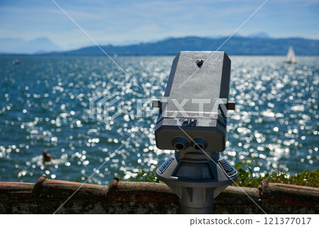Panoramic Binocular Overlooking Bodensee Sailboats and Swiss Alps from Lindau, Germany. Scenic Summer View Captures European Vacation Paradise with Yacht Racing and Mountain Vistas. Panoramic Binocular Overlooking Bodensee Sailboats and Swiss Alps from Lindau, Germany. Scenic Summer View Captures European Vacation Paradise with Yacht Racing and Mountain Vistas. 121377017