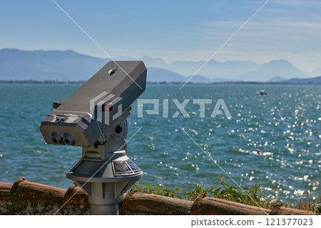 Panoramic Binocular Overlooking Bodensee Sailboats and Swiss Alps from Lindau, Germany. Scenic Summer View Captures European Vacation Paradise with Yacht Racing and Mountain Vistas. 121377023