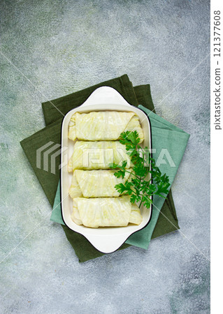 raw cabbage rolls, not cooked, with minced meat, top view, without people, in the spotlight. raw cabbage rolls, not cooked, with minced meat, top view, without people, in the spotlight. 121377608